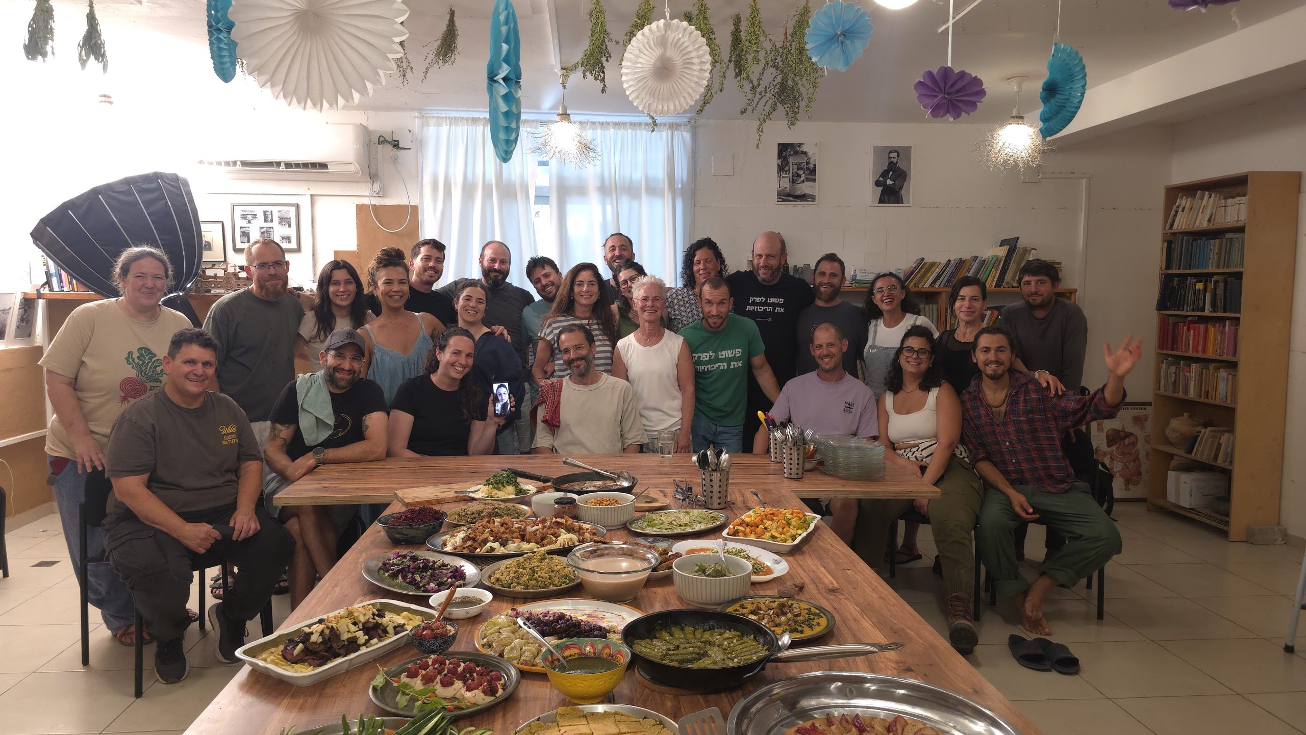 A group gathered around a shared meal at the Center