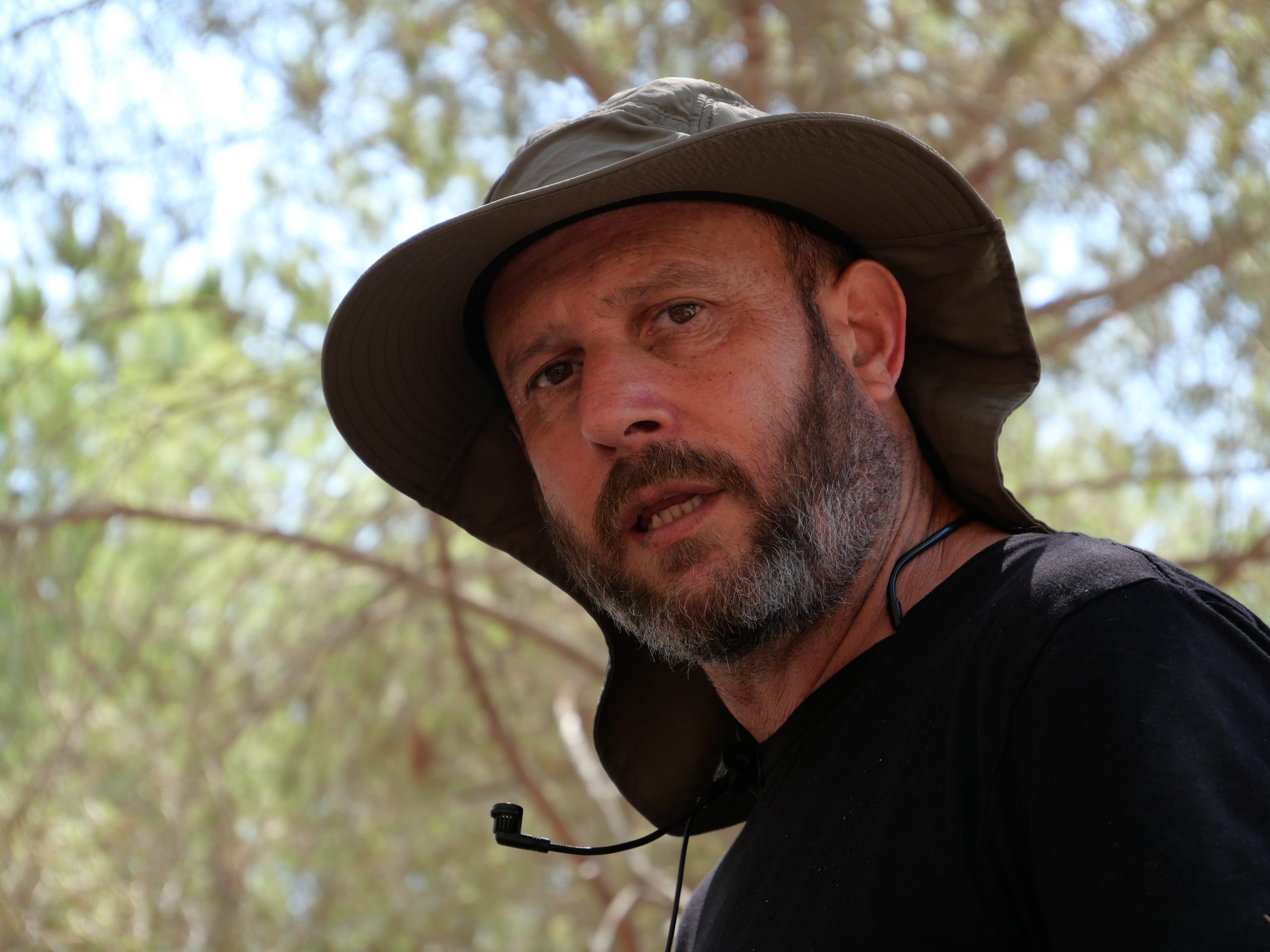 Uri Mayer Chissick teaching outdoors among local plants